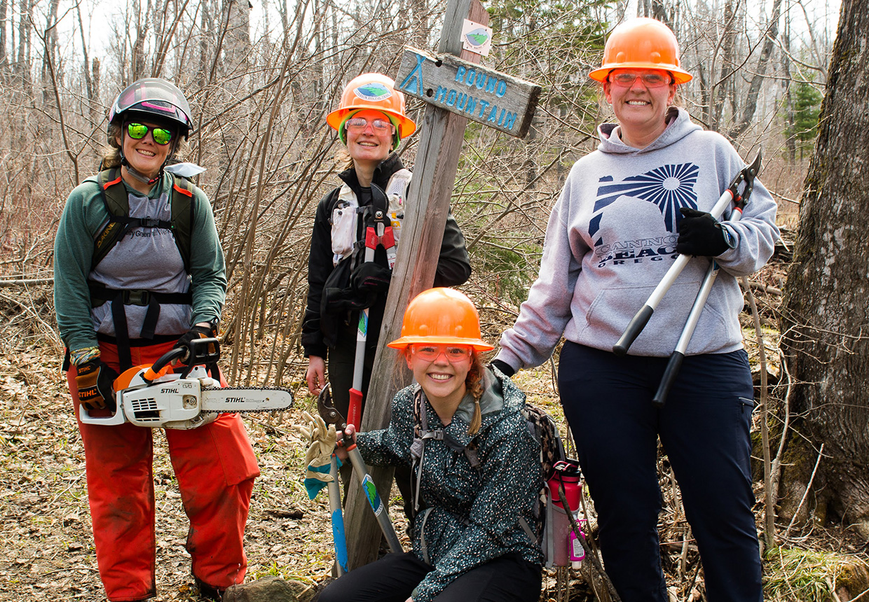 Photo of volunteer trail maintainers on the trail with their tools